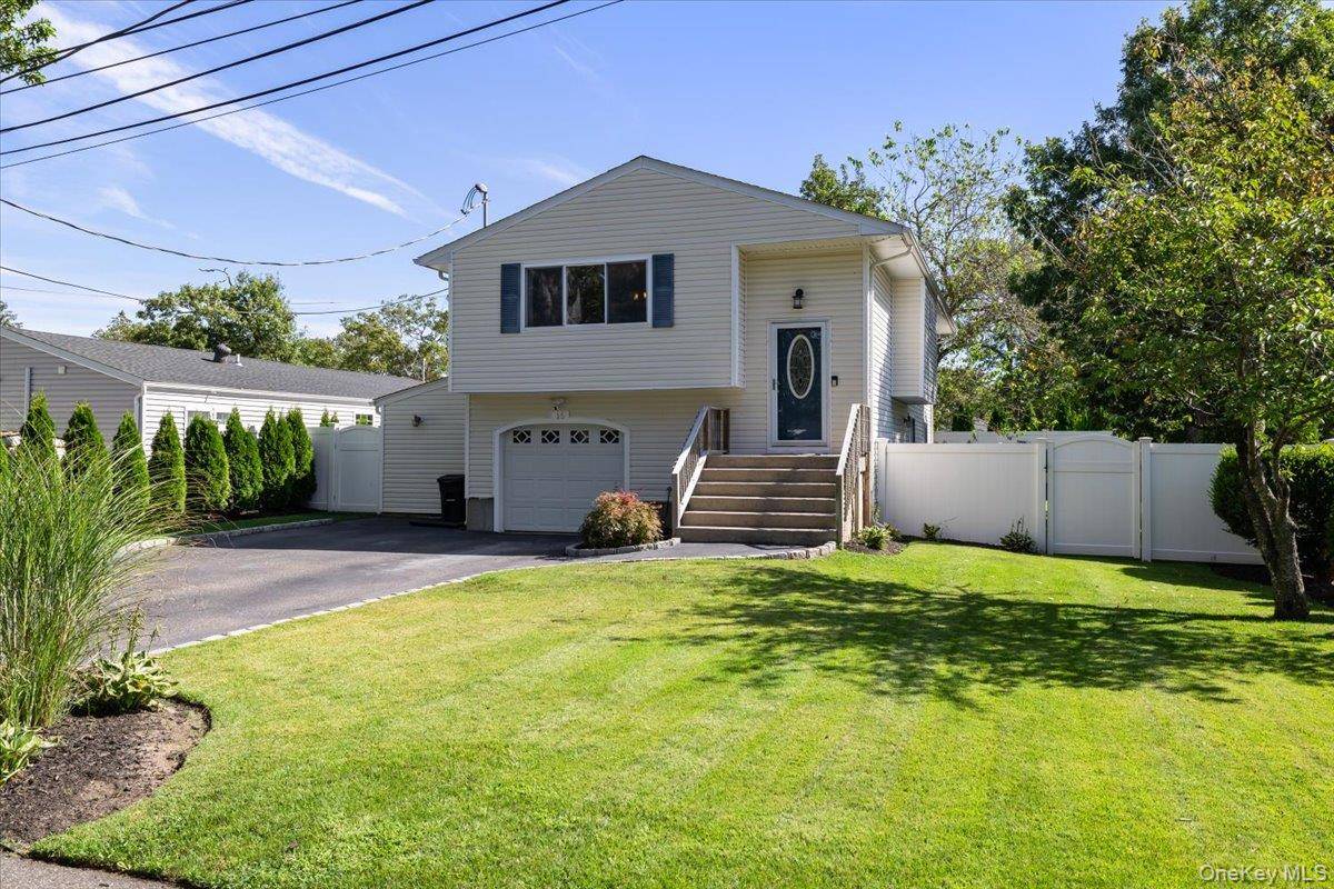 Welcome to this beautifully updated High Ranch, perfectly situated on a peaceful cul de sac in Patchogue.