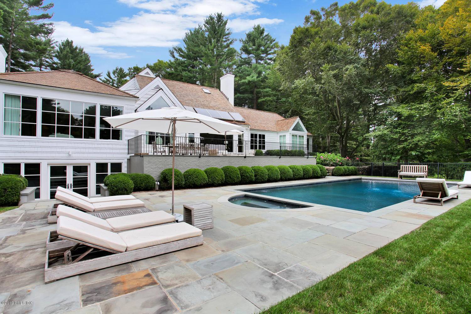 Architecturally striking Postmodern home with seven thousand square feet of updated spaces and serene vistas across a four acre property with sweeping velvety lawns and a private pond.
