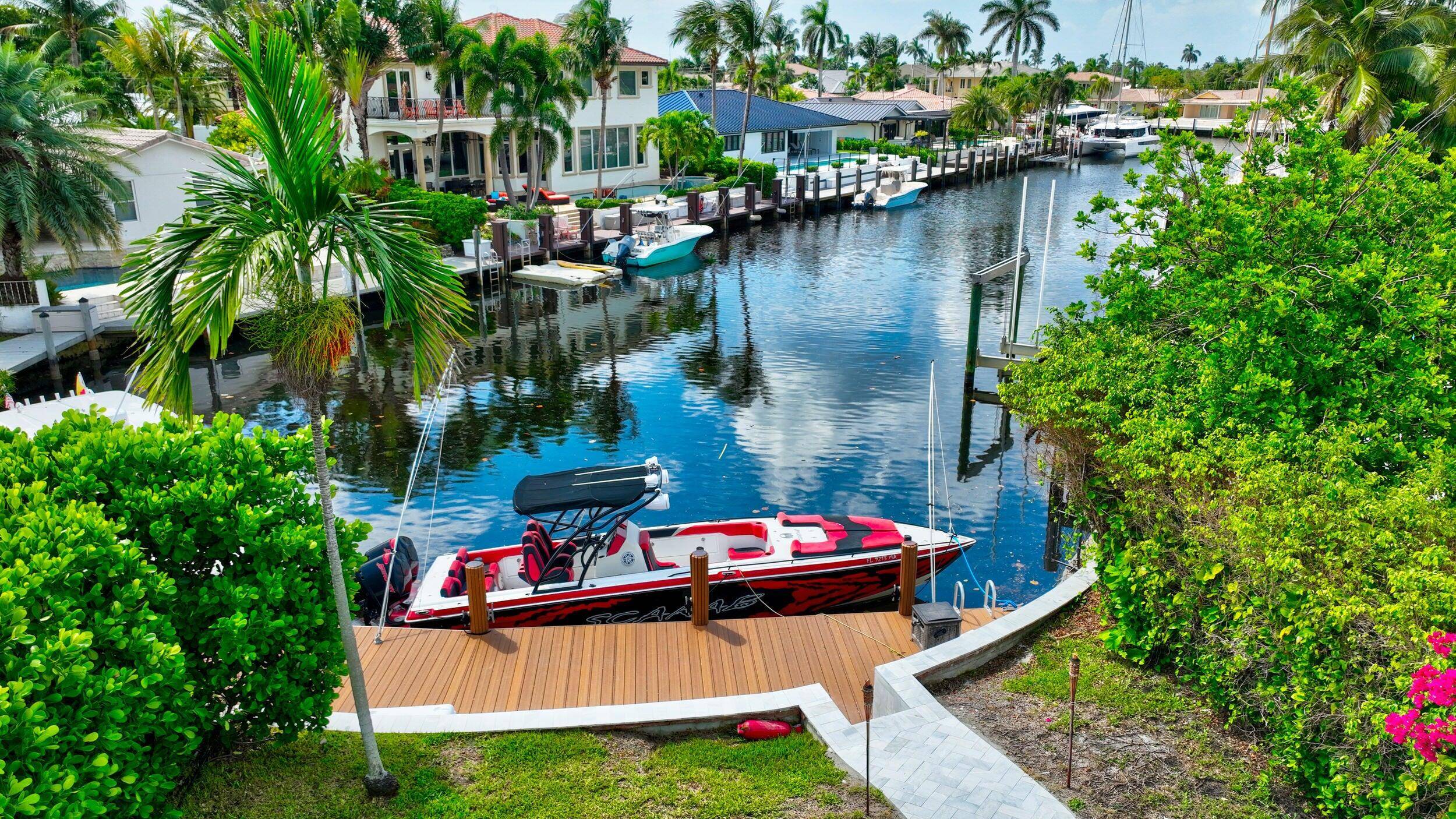 JUST BRING YOUR BOAT ! Stunning, fully renovated waterfront pool home with a guest house in prestigious Lighthouse Point, just off the North Grand Canal.