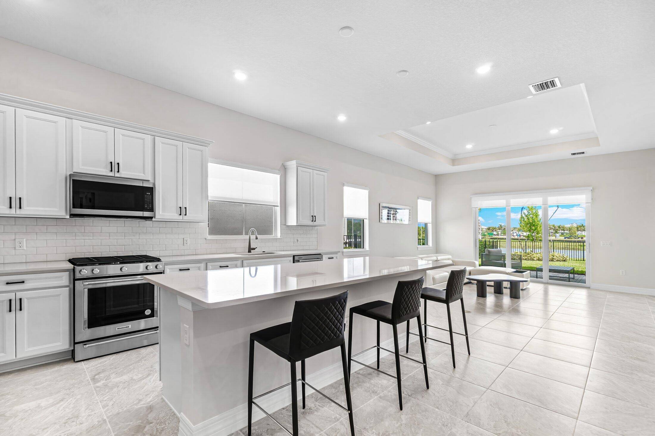 Waterfront luxury fully Furnished New Construction in PBG stunning new construction waterfront residence offersb3 spacious bedrooms plus a versatile den playroom office 4th bedroom.
