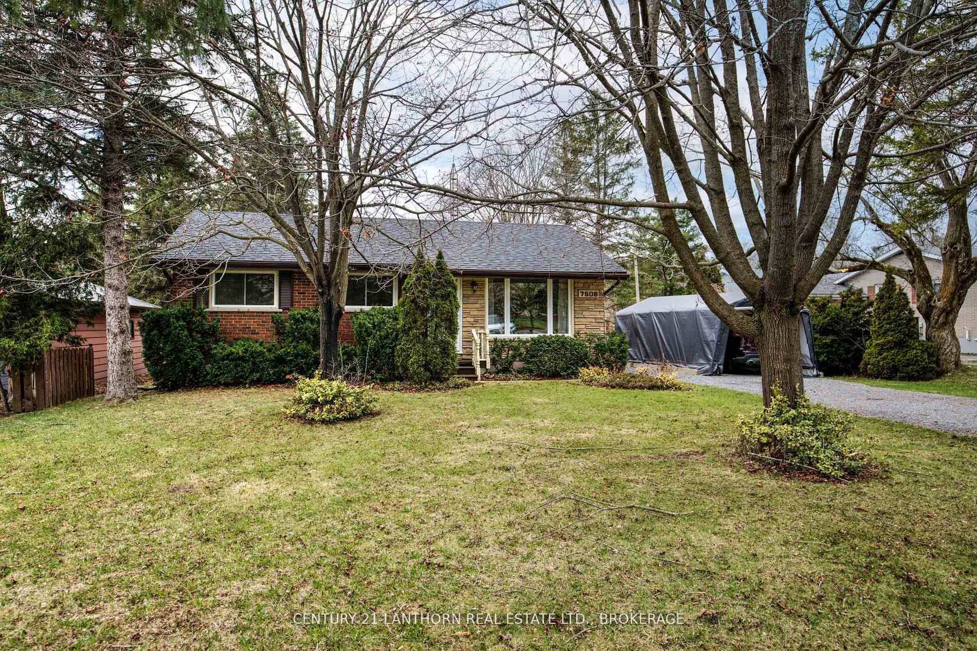 Charming and appealing all brick bungalow on a large, well manicured lot just minutes from town !