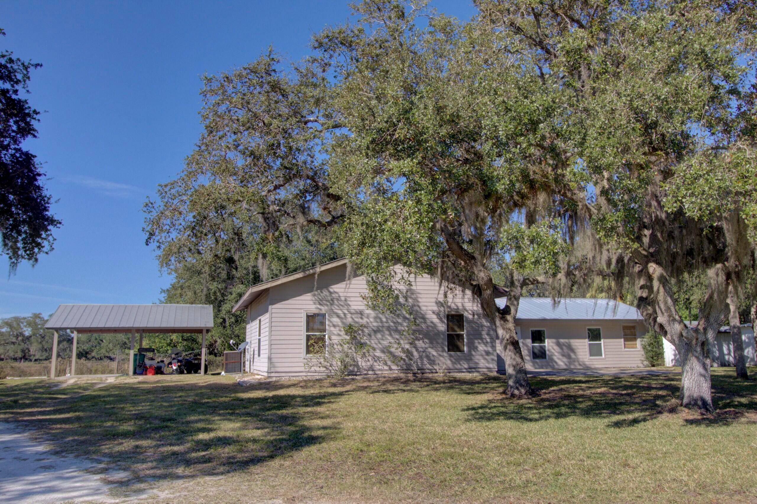 Escape to peaceful rural living on this fenced 10 acre property in Moore Haven !