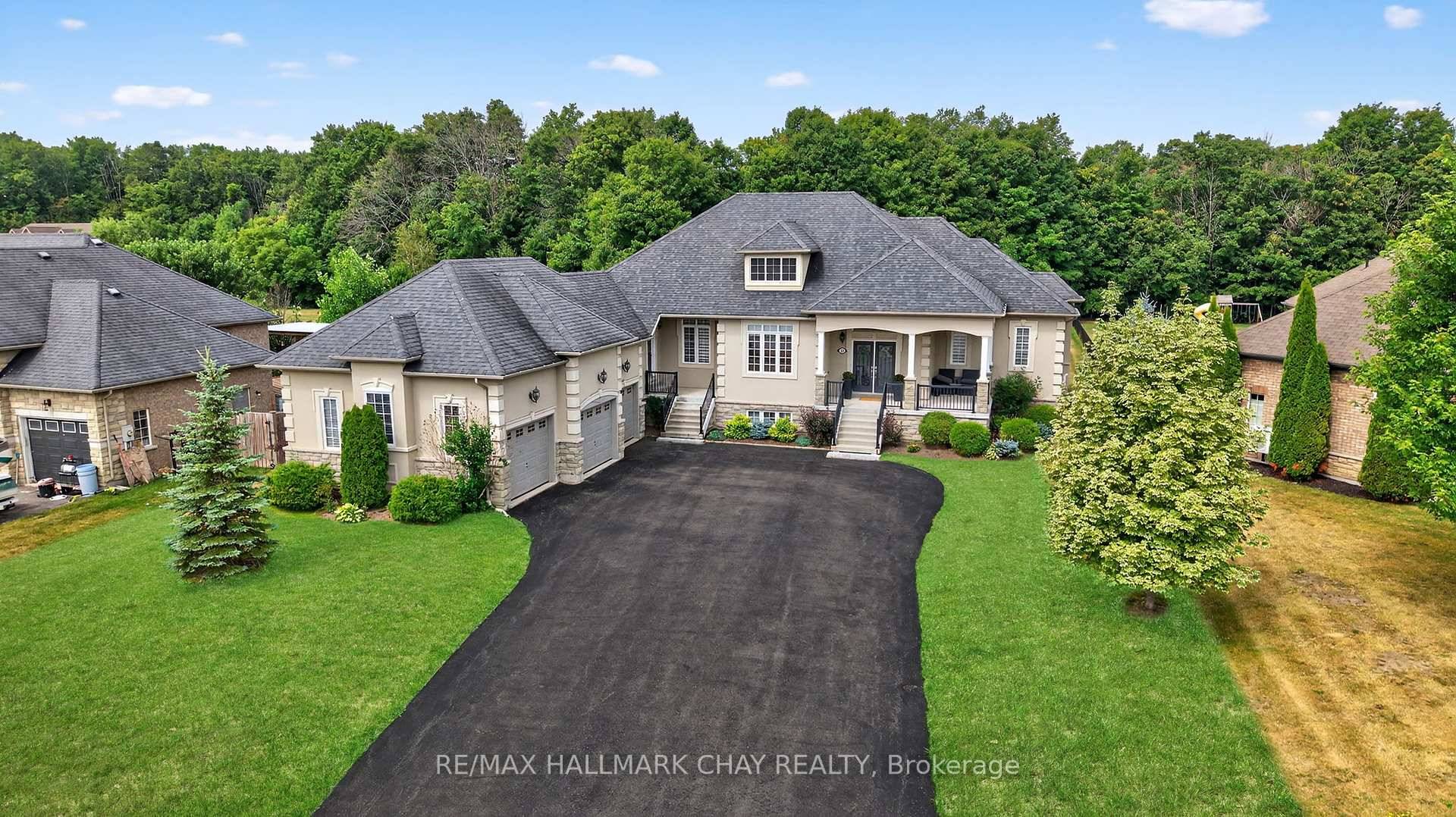 Step into this impressive raised bungalow in Wasaga Beach's prestigious Wasaga Sands Estates, set on a rare ravine lot surrounded by expansive estate properties.