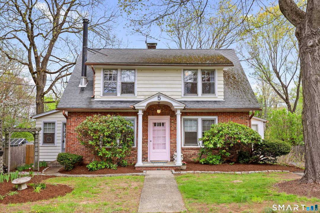 This charming brick and clapboard cape is a fantastic opportunity in a prime location.