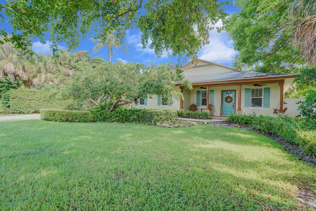 This is a charming 4 bedroom with an office den or 3 bedroom plus office flex space with pool, outdoor lounging area and a welcoming front porch with a swing, ...
