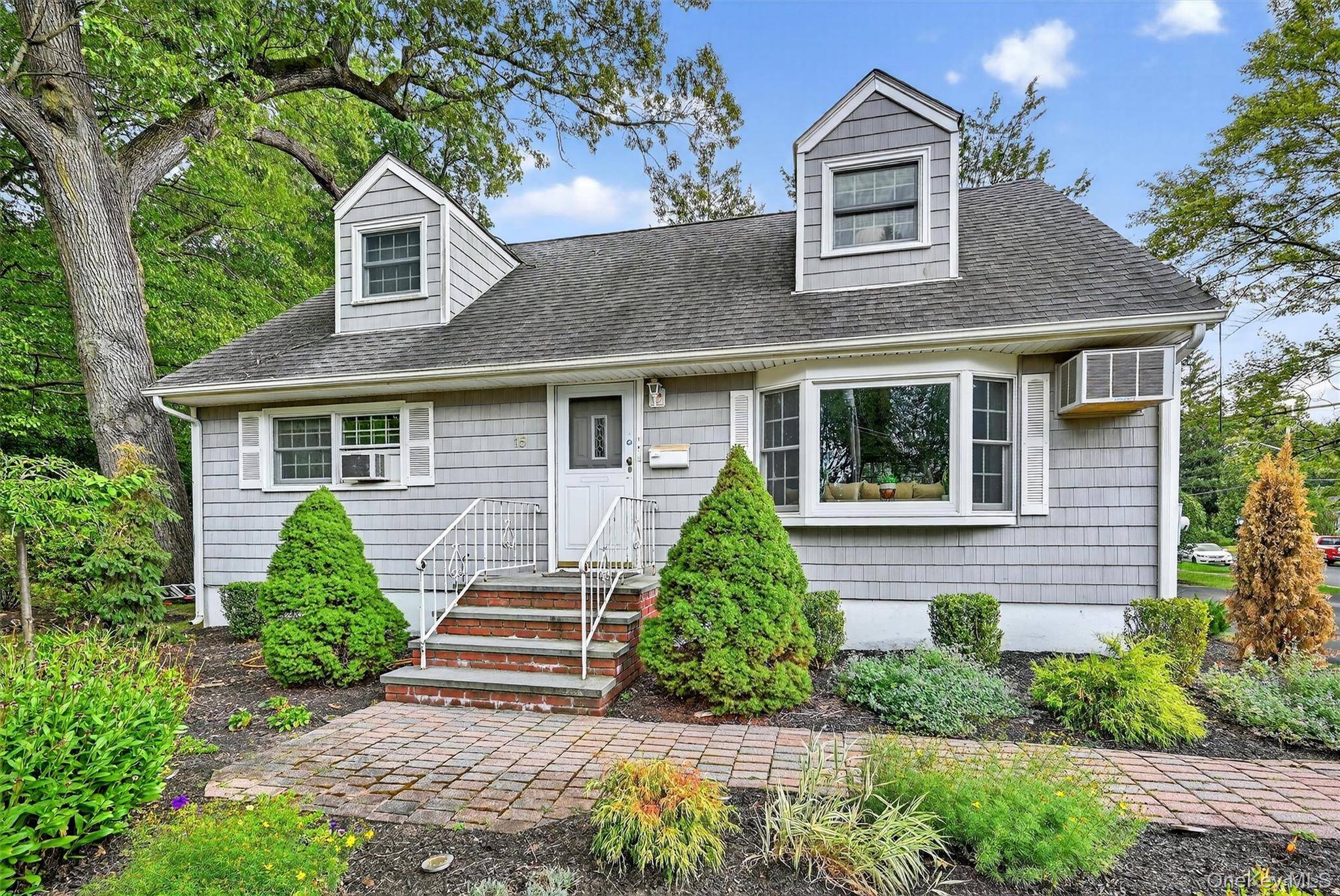 Discover the perfect blend of comfort and convenience in this picture perfect 5 bedroom Cape Cod colonial, nestled on a serene, picturesque street in the heart of New City, NY.