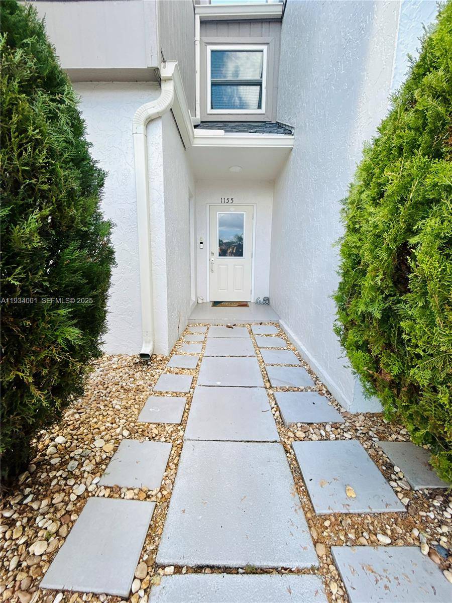 Stunning waterfront townhome in the heart of Wellington with NO HOA.