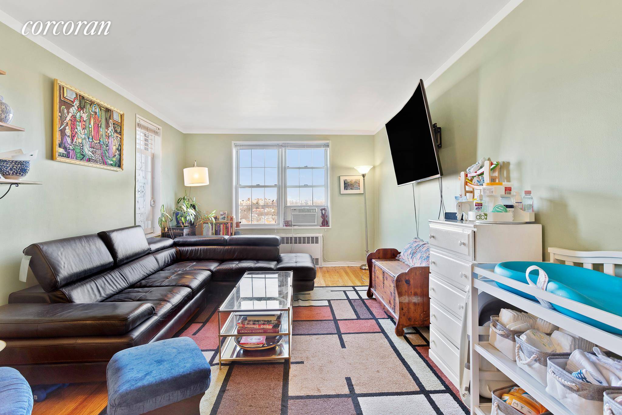 Sunny and sprawling one bedroom convertible 2BR apartment in a well maintained building on a pretty, tree lined block in vibrant Rego Park.