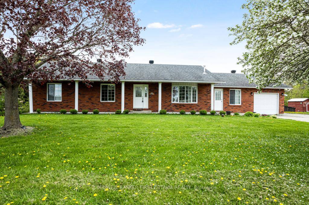 Attractive, curb appeal, brick bungalow with attached single garage plus, detached garage workshop.