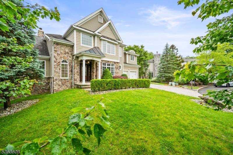 Experience Timeless Elegance in the Coveted Cotswold Section Welcome to refined luxury in this breathtaking stone front Colonial, gracefully set on 0.