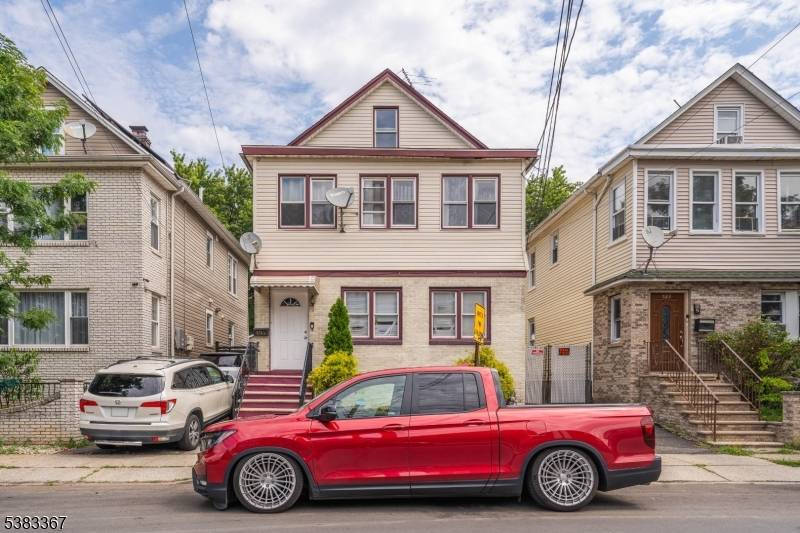 INCOME PRODUCING TWO FAMILY with 3 bedrooms on each floor, plenty of storage in a partially finished basement and unfinished attic.