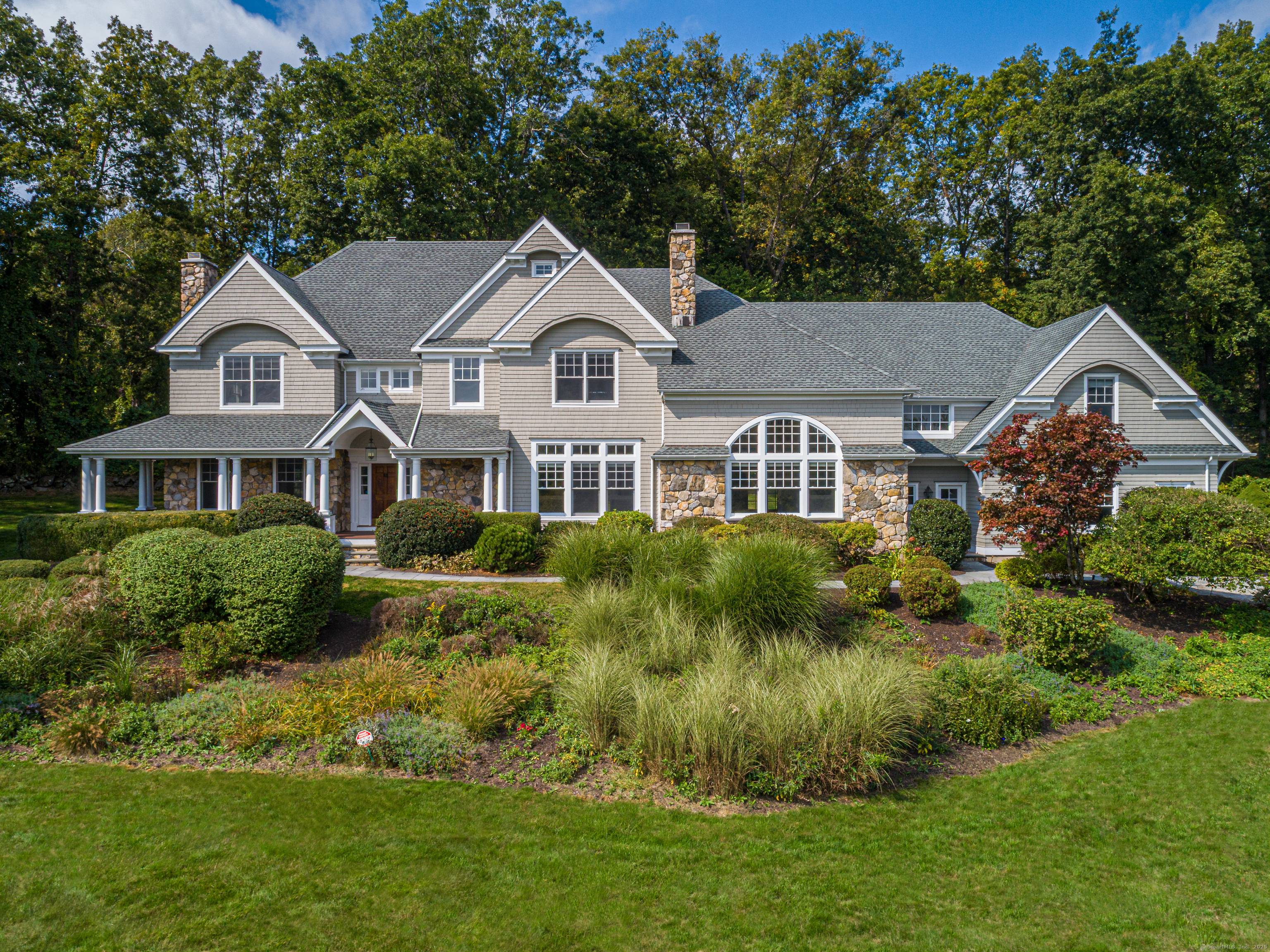 This stunning custom Colonial by renowned architect Rick Moisan combines timeless design and modern comfort on 2.
