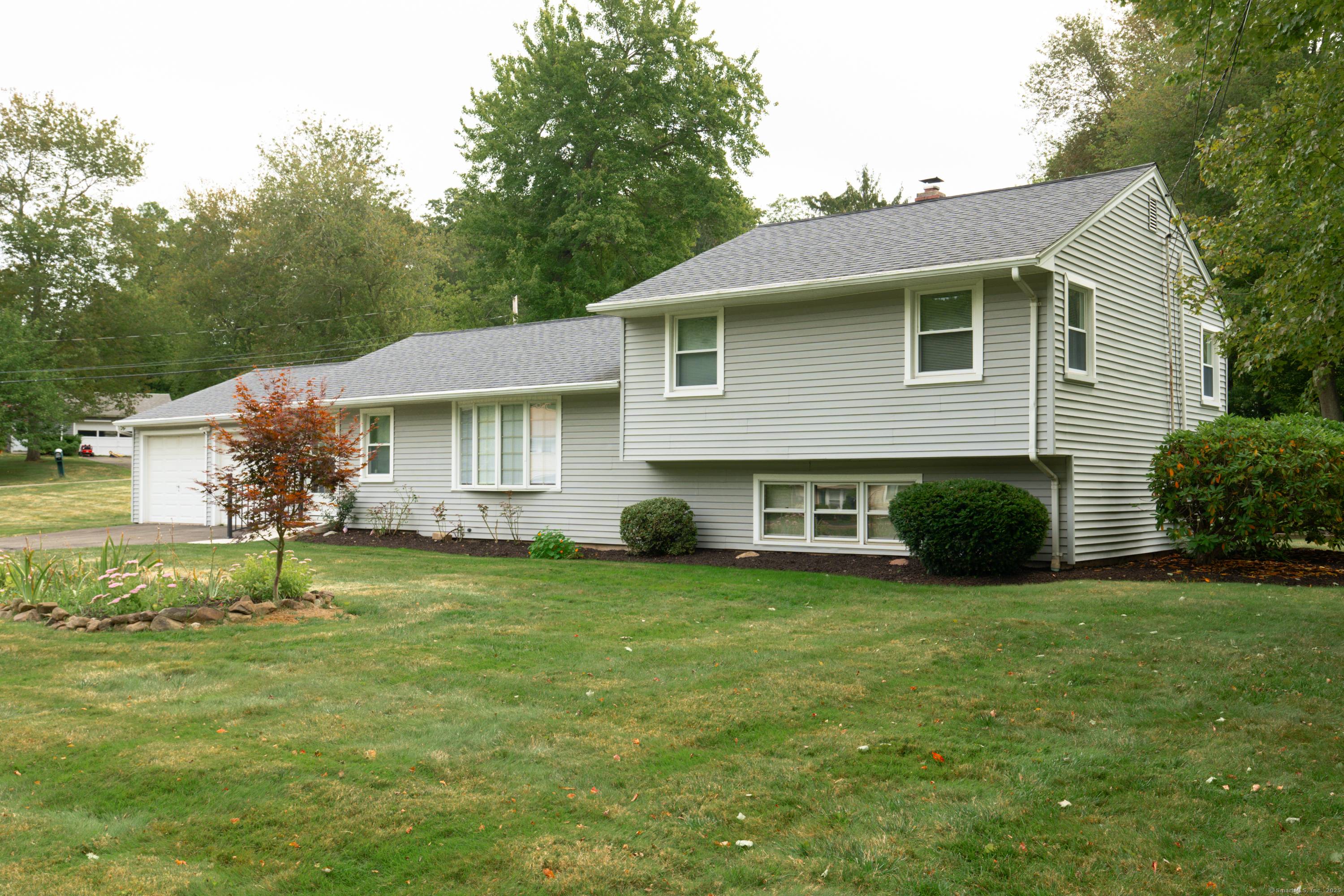 Welcome to this corner lot home with multiple living areas and a large, manicured yard.
