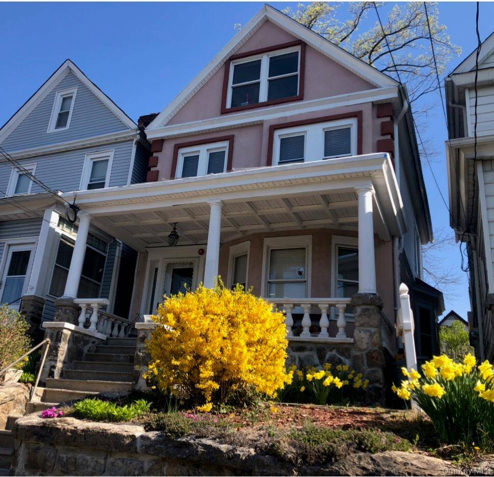 This single family residence in East Yonkers features beautiful stucco on the exterior.