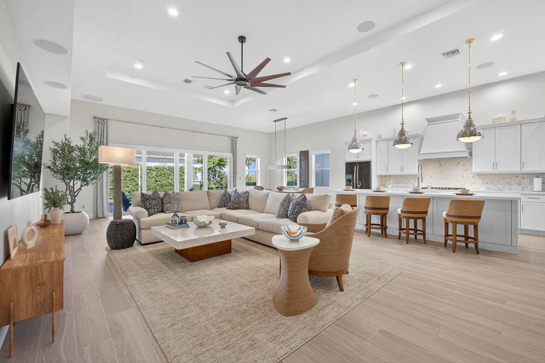This Inviting home greets you with a covered porch and a welcoming entry, leading into a grand foyer that opens to an expansive great room with a resort style ambiance.
