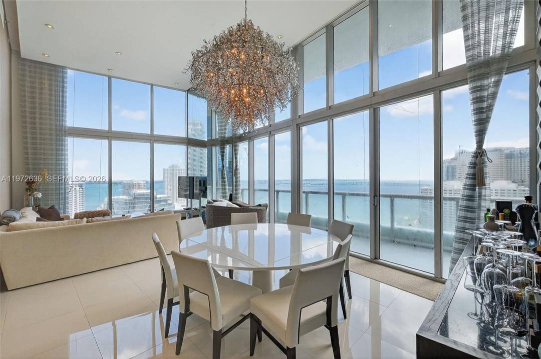 READY TO MOVE IN ! ! Live in luxury in this impressive Brickell condominium featuring double height ceilings, panoramic ocean views, and professional de cor.