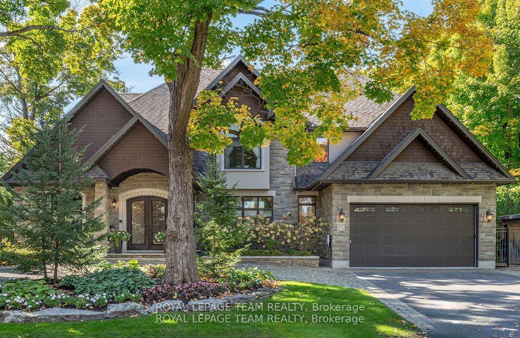 Visit Rockcliffe Park to discover a stunning home of stone, arched windows, stately pillars, double garage, and magnificent peaks.