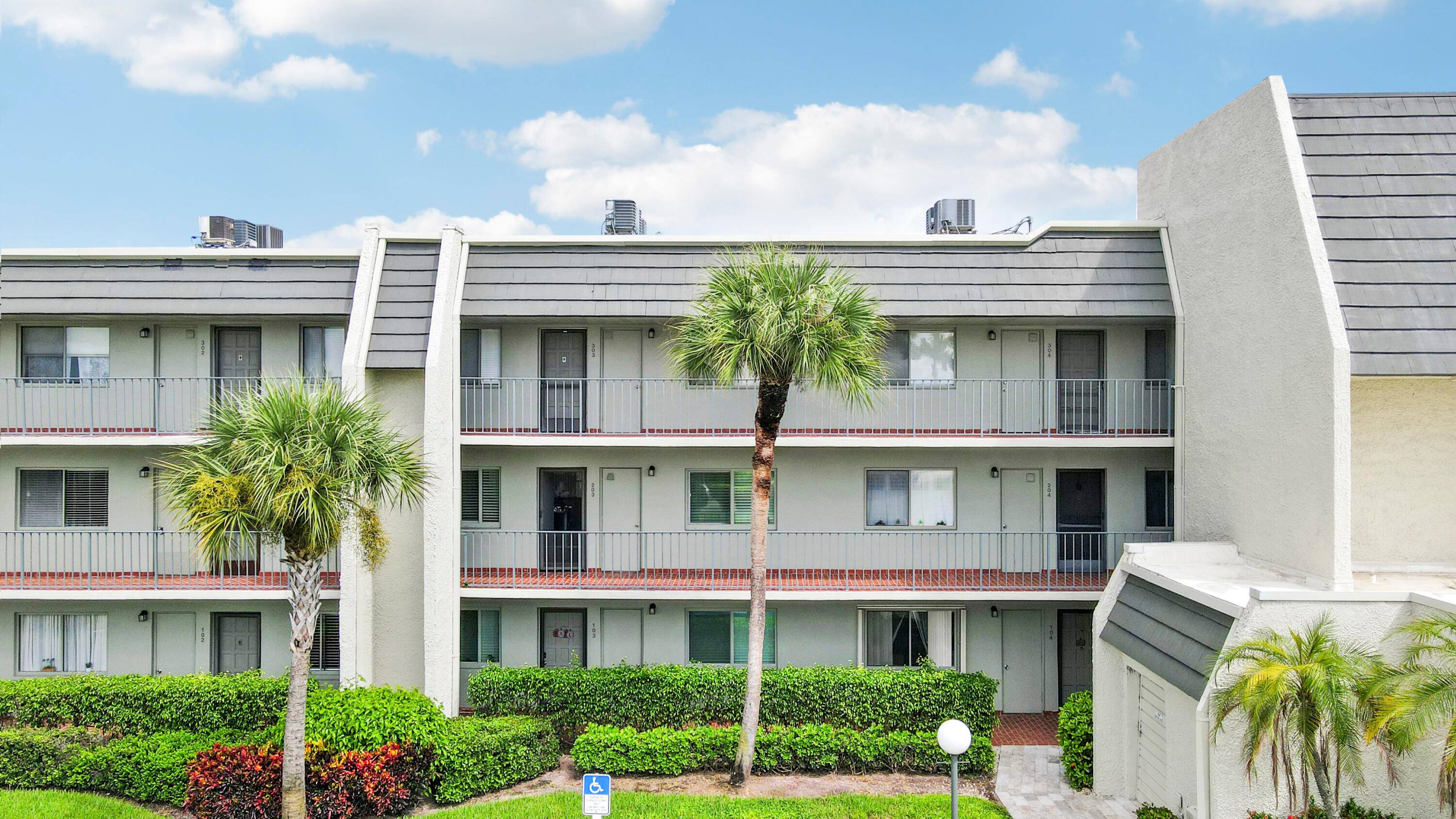 Sun splashed and move in ready, this airy second floor residence in gated Fountains Country Club blends easy living with a resort setting.