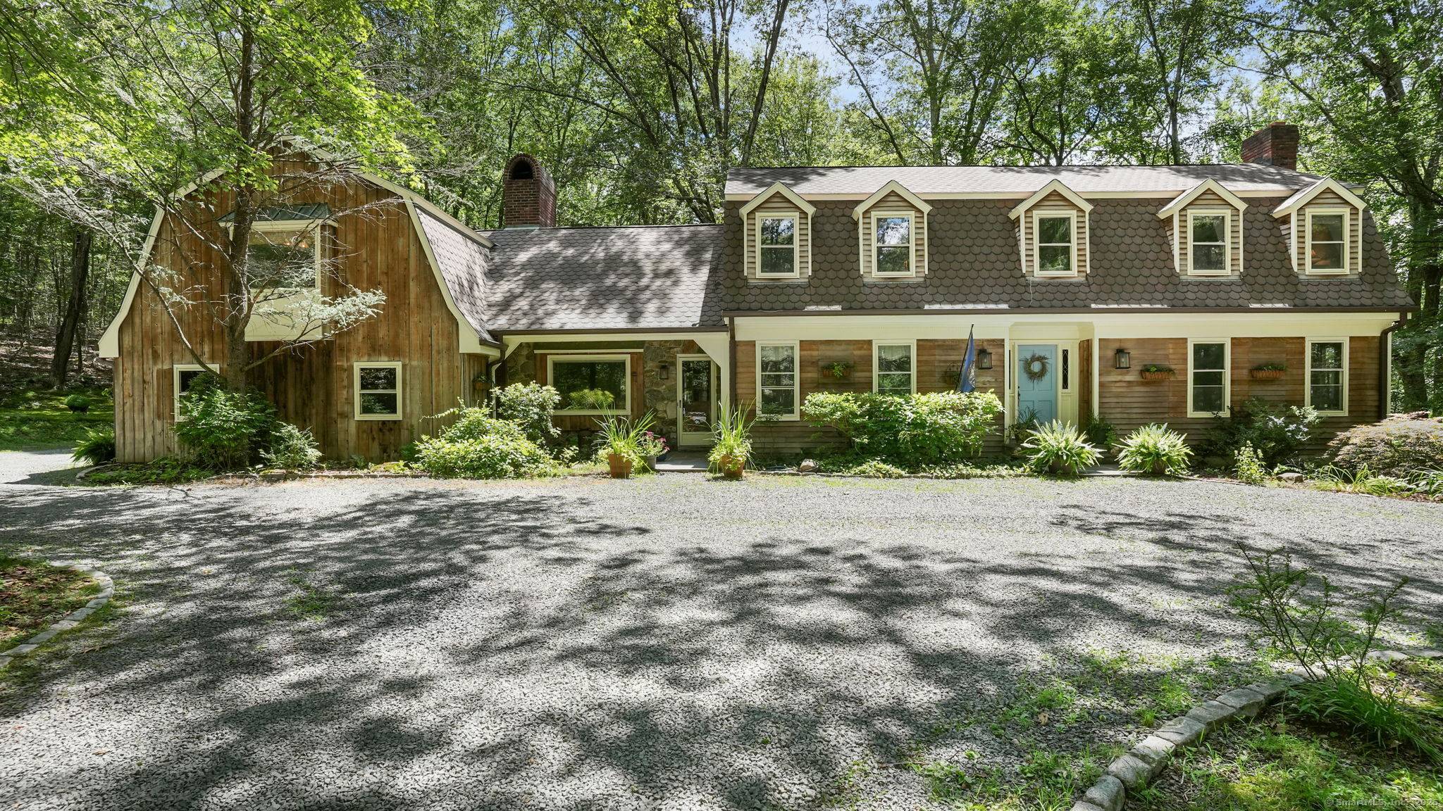 Tucked away at the end of a serene cul de sac, abutting protected land, is this timeless forever home.