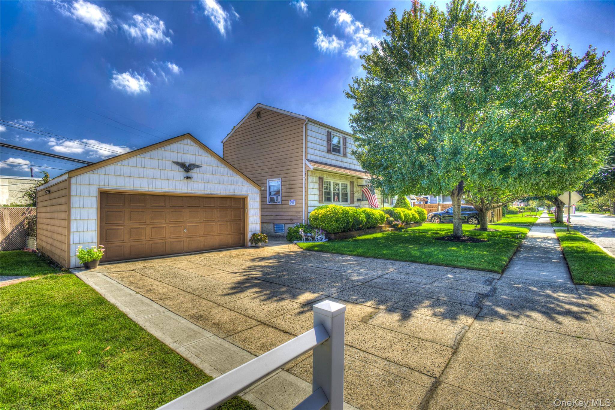 Beautifully manicured property frames this lovingly maintained Two Family Dwelling constructed to accommodate year round occupancy.
