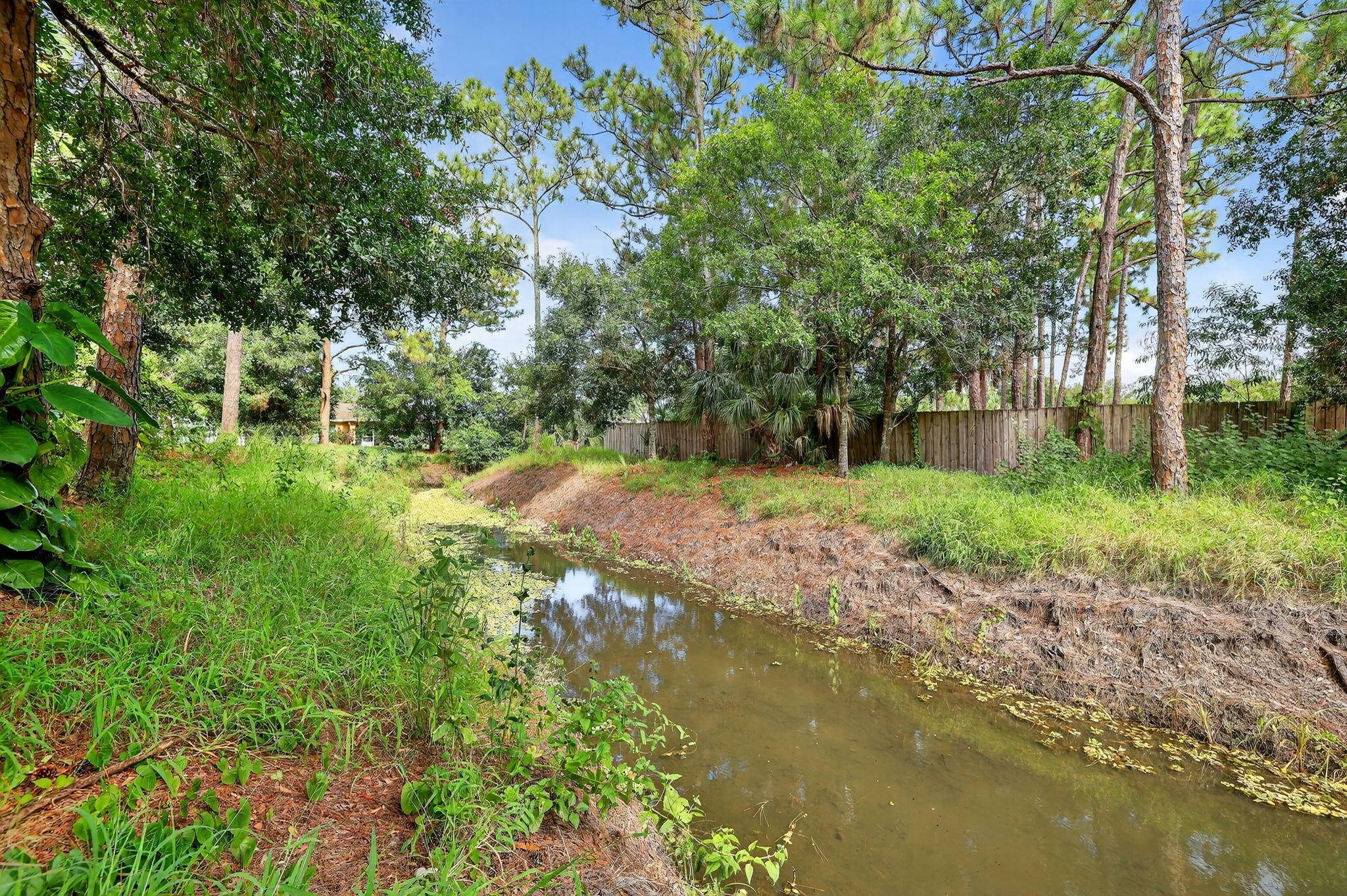 NICE 1 3 ACRE PIE SHAPED LOT LOCATED ON A CANAL IN AN AREA WITH GOOD SCHOOLS, SHOPPING AND HIGHWAYS.