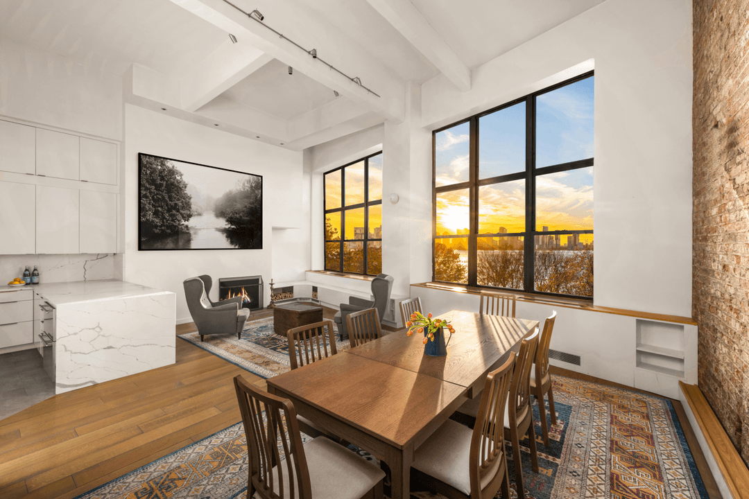 Rarely available duplex loft with 15 ft ceilings and massive windows showcasing spectacular Hudson River views in the heart of the West Village.