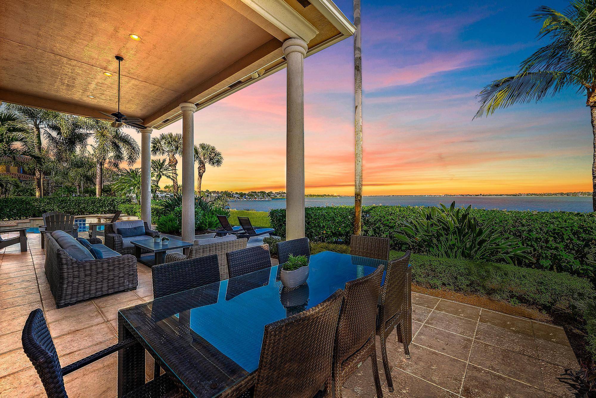 Nestled within the exclusive Palm Cove Golf Yacht Club, this custom built estate offers sweeping, mile long river views from nearly every room.