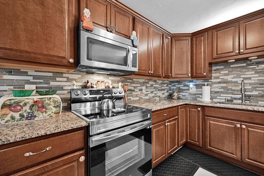 Gorgeous 2 bedroom, 2 bath condo with alcove study office area and enclosed patio in the beautiful, resort style, 55 community of Banyan Springs.