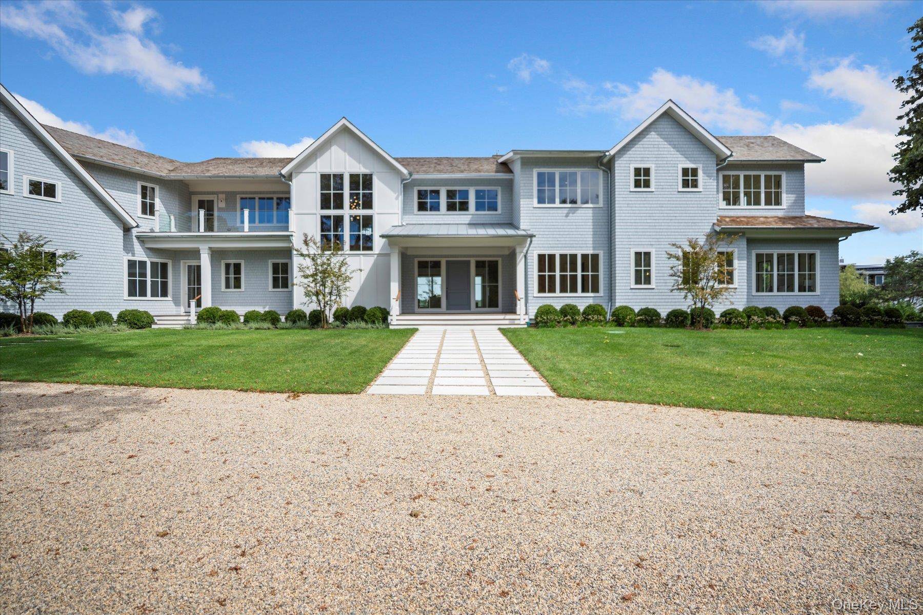 Discover the ultimate in luxury living on 3 private acres with 225 feet of bulkhead along the serene Quantuck Creek in Quiogue.