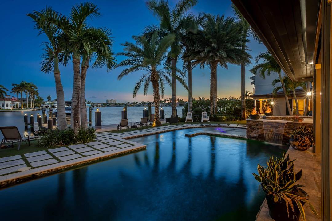 Welcome to a rare jewel of South Florida living this architecturally stunning, custom rebuilt waterfront estate blends timeless elegance with modern coastal sophistication.