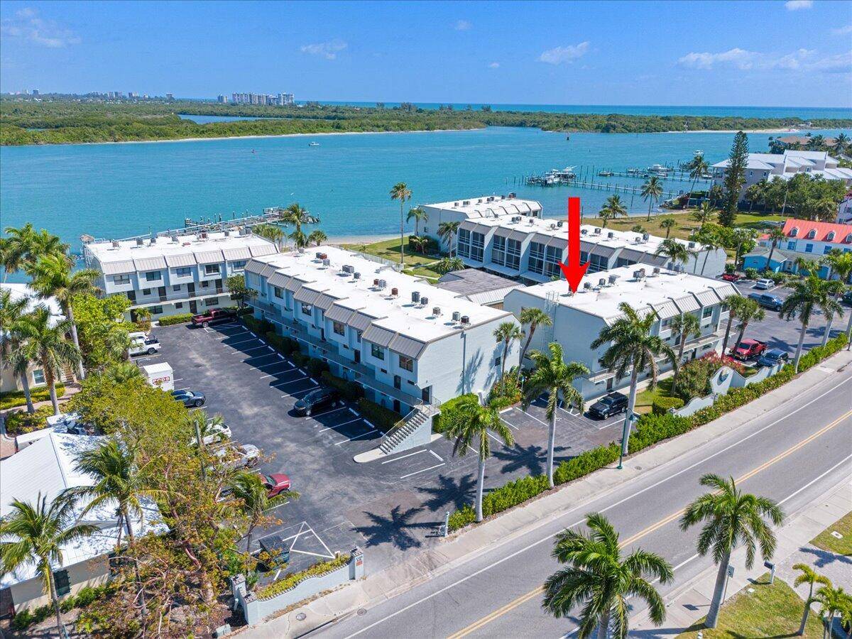ENJOY ISLAND LIVING DIRECTLY ON INLET WITH DOCKS AND PRIVATE BEACH.