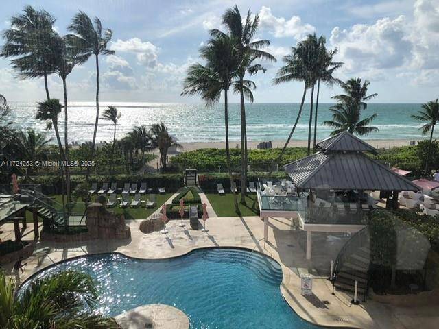 Experience stunning, unobstructed direct ocean and pool views from this fully furnished SE corner unit at the Alexander Hotel.