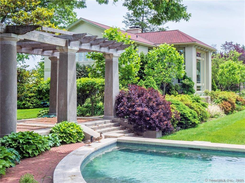 Secluded Mediterranean inspired estate located on prestigious Bluewater Hill South with tennis courts and private beach rights to Compo Beach located steps away.