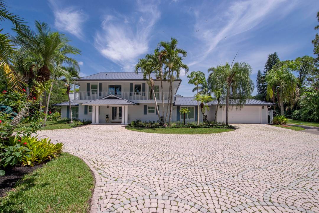 Escape to your private South Florida sanctuary, a modern French Country estate that redefines refined living on over five acres of lush, equestrian land.