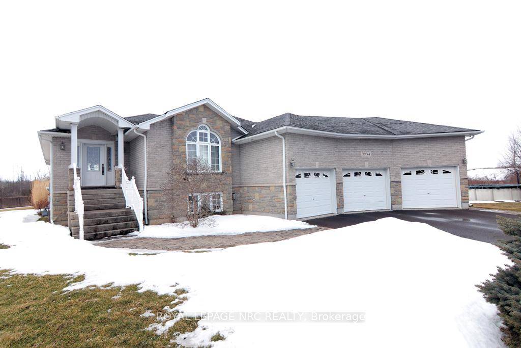 Custom Built Bilevel with In Law Suite Potential and a Dream Garage !