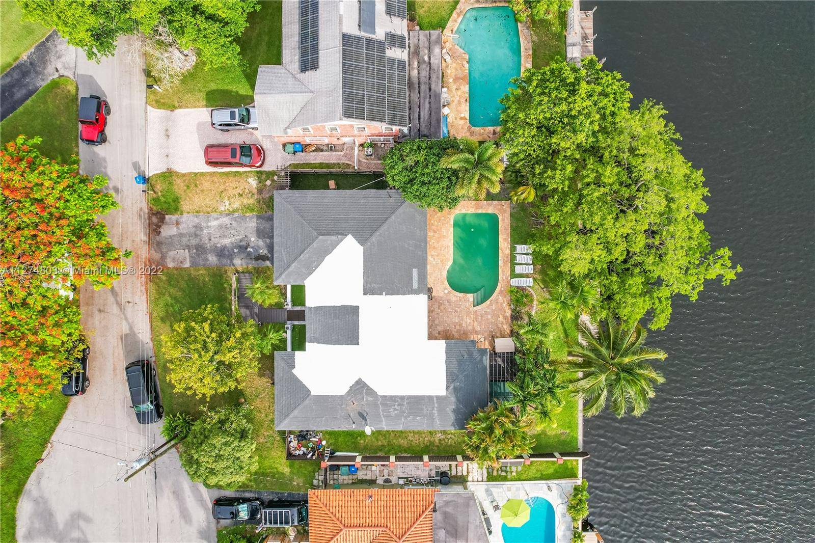 Outstanding renovated Waterfront Home with pool and wide intercoastal canal with wood deck.