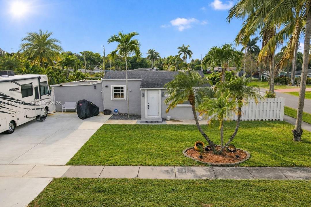 Tropical Hallandale Beach property offering a private, resort style backyard perfect for outdoor living and entertaining.