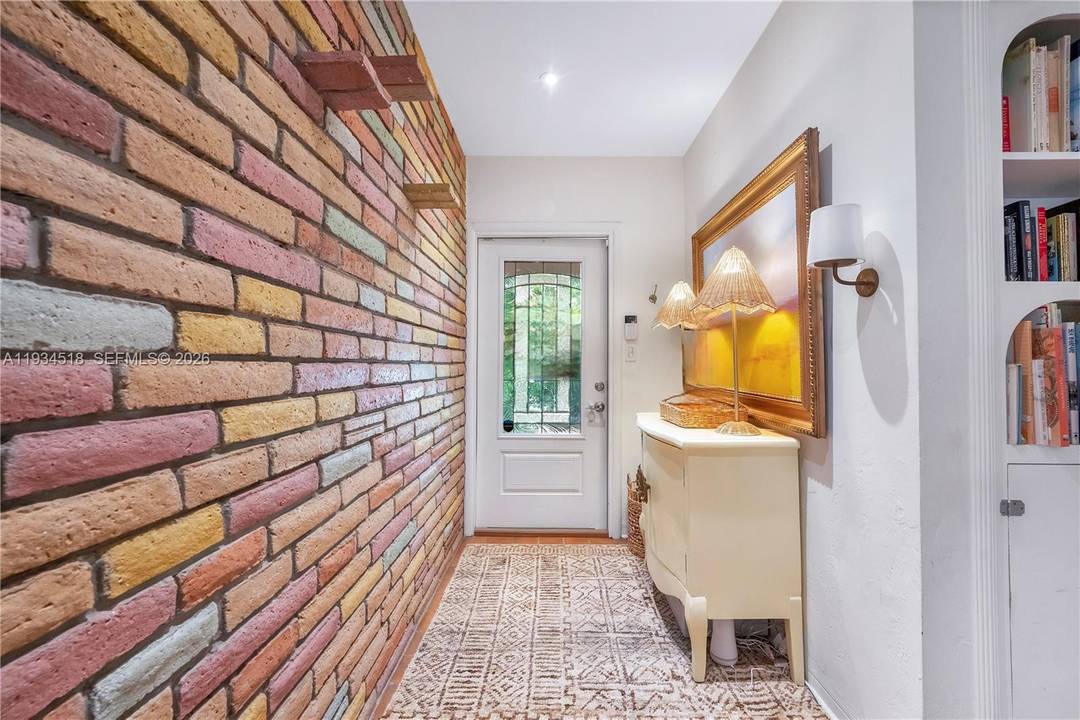 Discover this meticulously renovated Coconut Grove retreat where 1940s character meets modern sophistication.