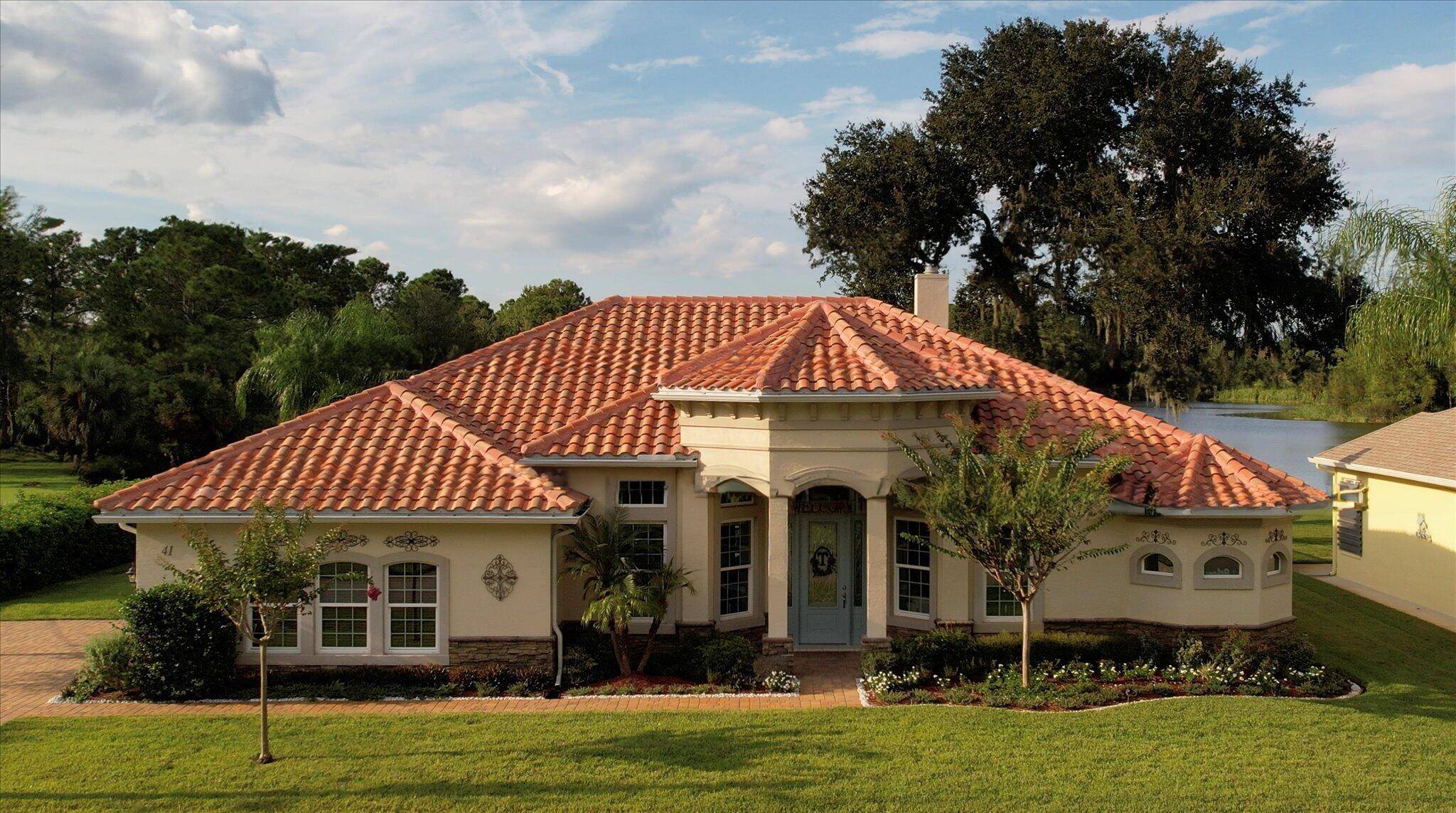 Vanacore Custom Built in 2017, this stunning tile roofed pool home backs to a serene lake and preserve.
