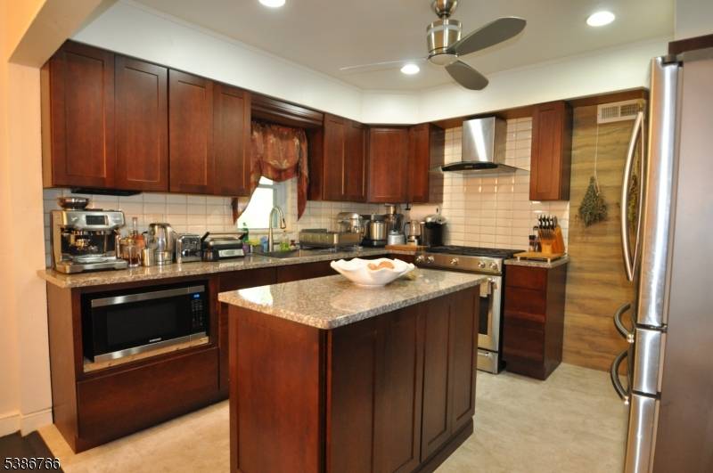 Charming Custom Cape Cod Home This well maintained residence features four spacious bedrooms and three full bathrooms.