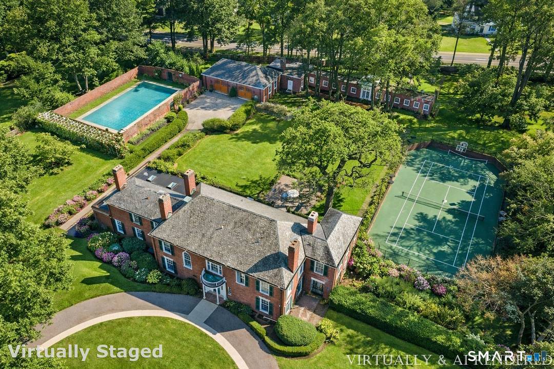 Iconic Georgian Manor. A rare offering of architectural significance, this distinguished 1922 Georgian Colonial is set on 1.