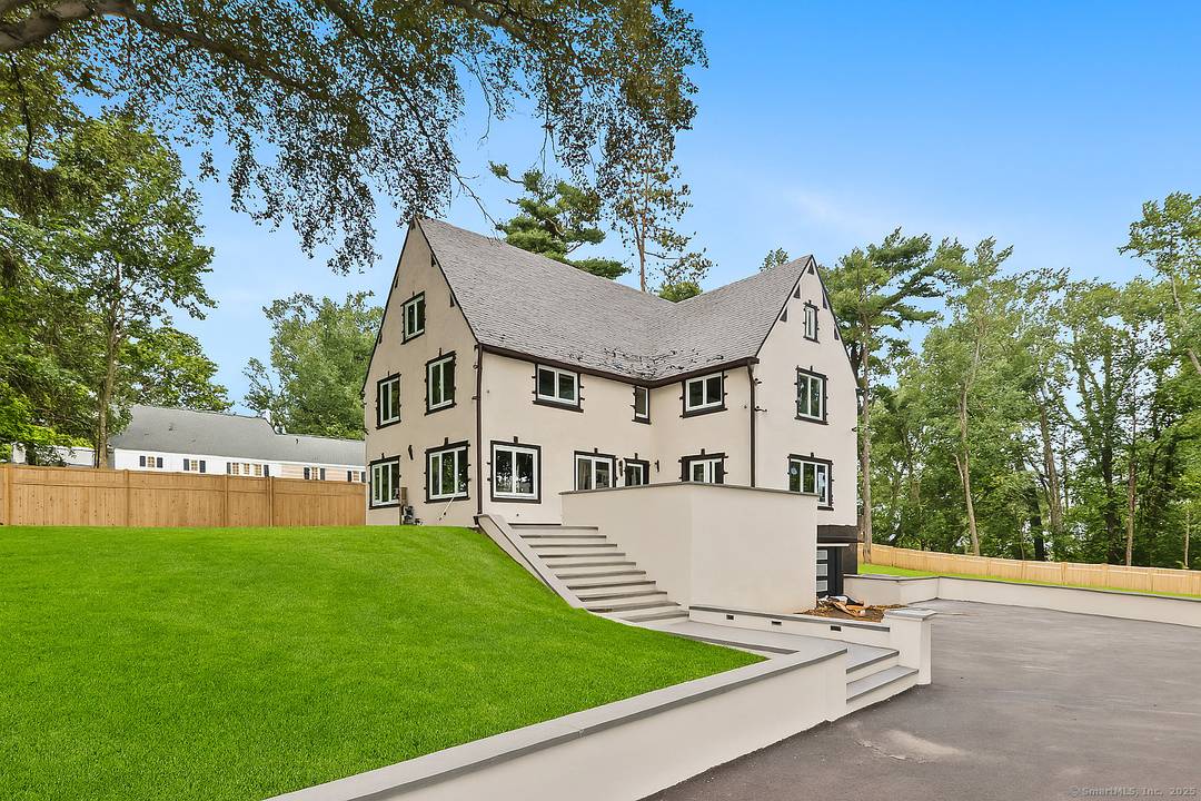 Welcome to this extraordinary European inspired brick and stucco Tudor estate, situated on a beautifully landscaped, level.