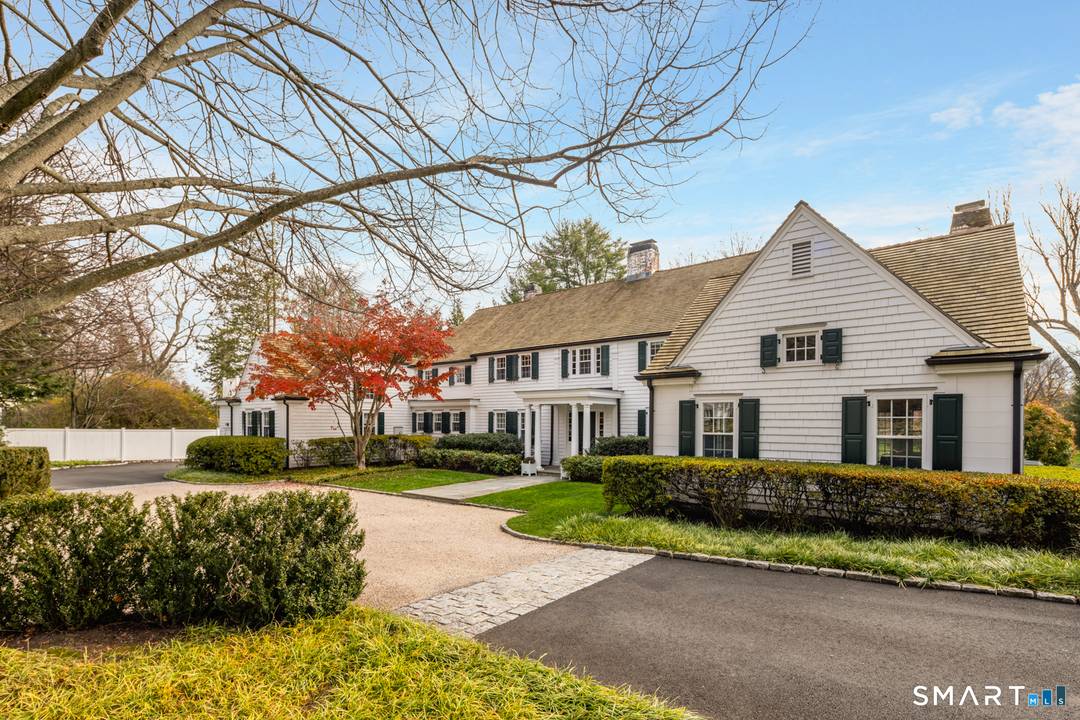 One of New Canaan's distinguished landmark residences, this extraordinary home is gracefully sited on 2.