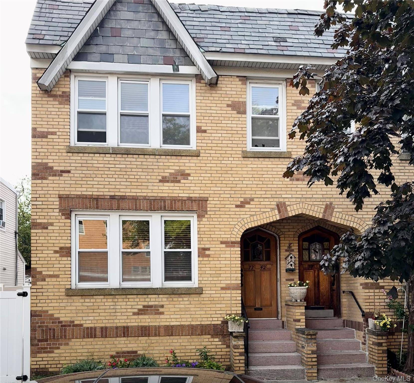 Presenting 77 42, a semi detached two family brick home ideally situated in Glendale.