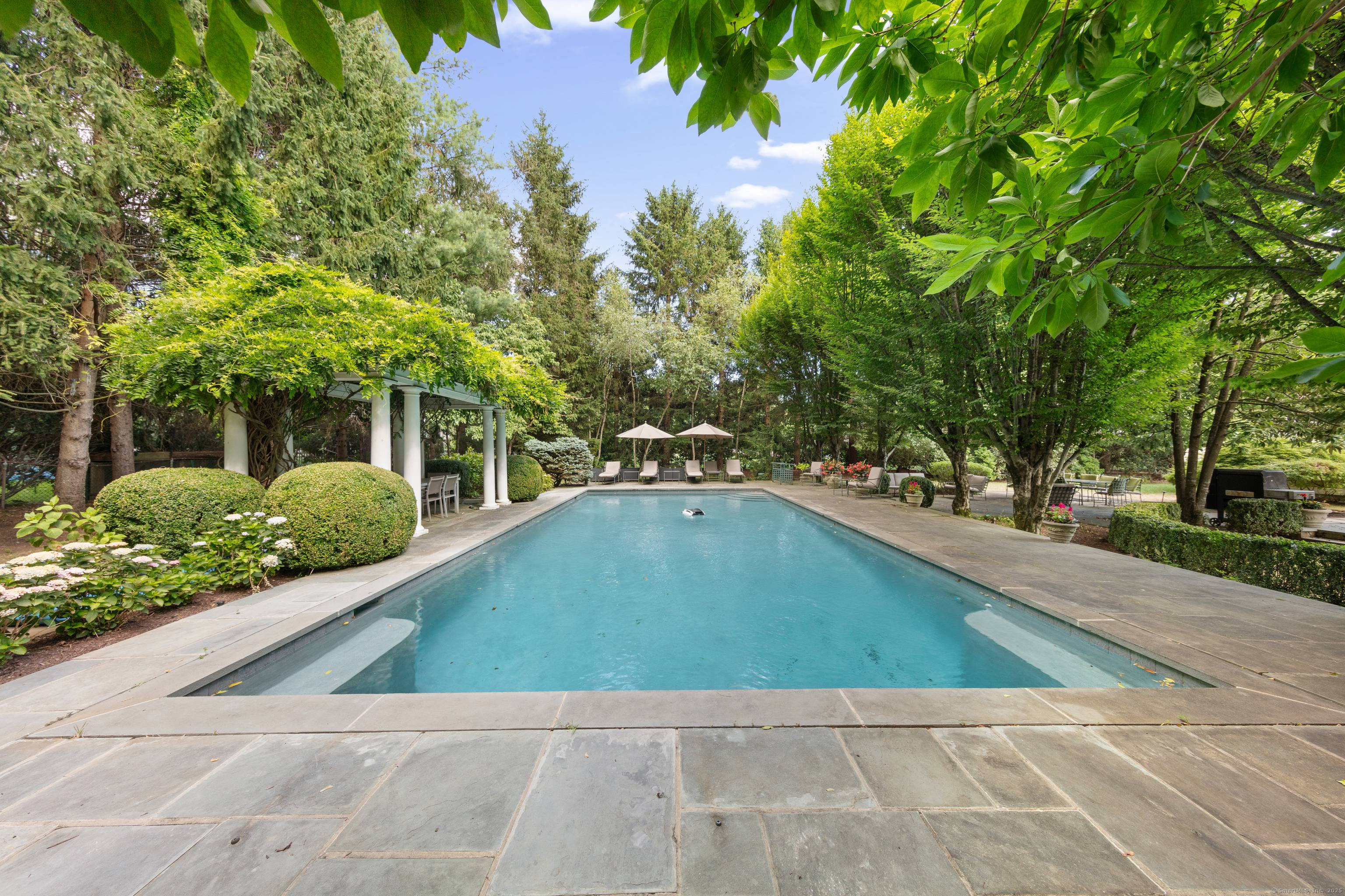 Beautifully renovated vintage home offers timeless character on a professionally landscaped acre in coveted Old Hill.