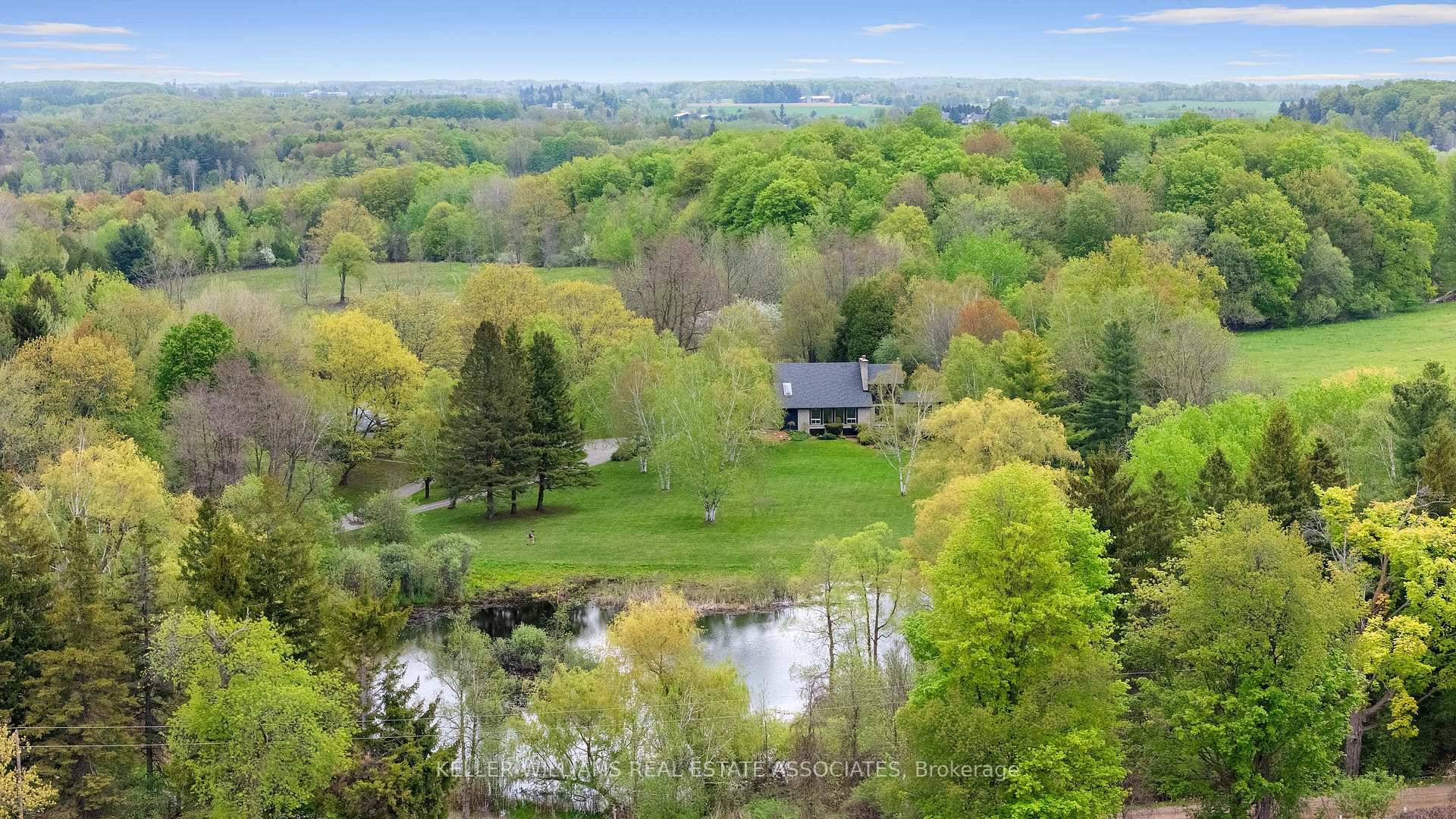 Idyllic Rural Caledon Location, A Winding Driveway Takes You To A Breathtaking 25 Acre Estate With Rolling Hills, 8 acres Farmland, Offering Unparalleled Privacy Complete With A Large Tranquil Pond.