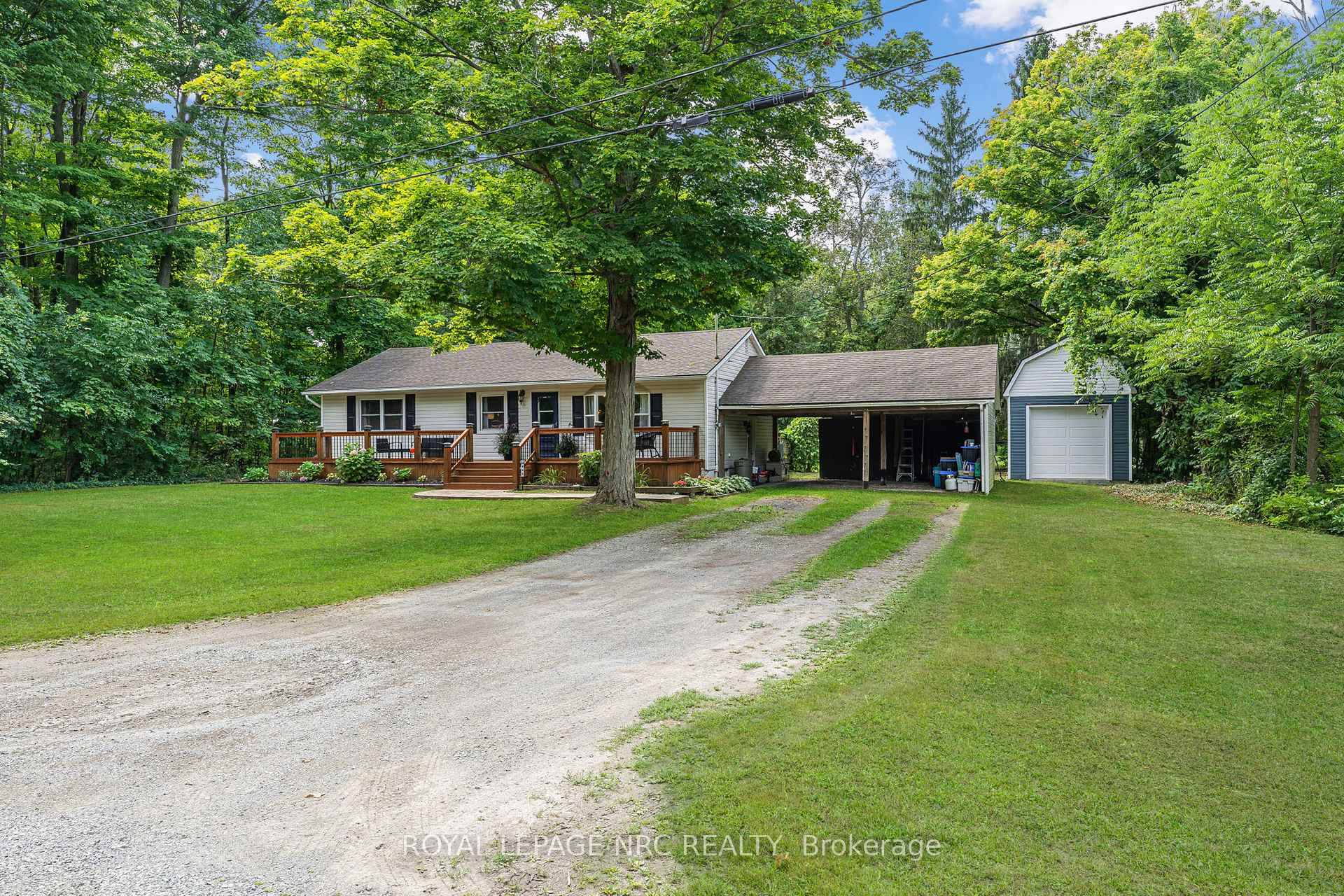Welcome to 445 Gloria Road, a charming bungalow tucked away in a peaceful, wooded setting in Ridgeway.