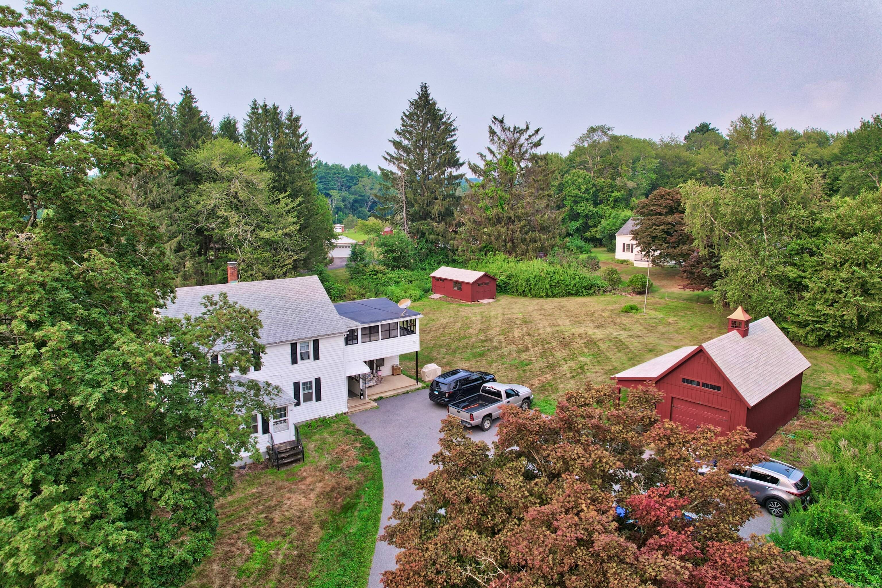 Charming Two Family home situated on over three quarters of an acre !