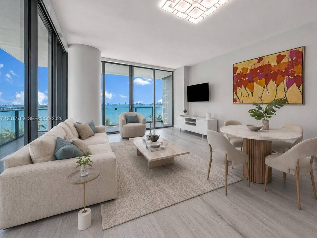 Spectacular 3BD 3BA oversized den move in ready corner residence in the heart of Edgewater with an enormous wraparound balcony showcasing stunning bay and city views.