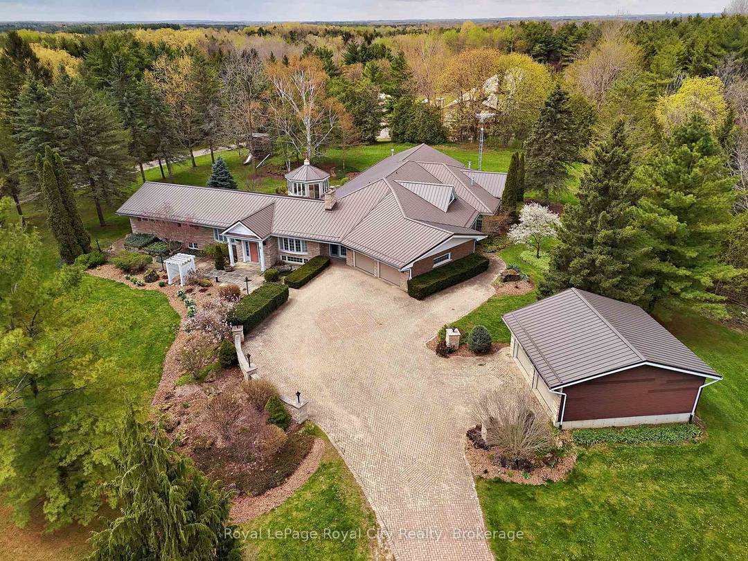 Nestled on 16. 5 acres in picturesque Puslinch, this enchanting custom bungalow is accessed by a grand brick driveway leading up to a truly unique lifestyle property.